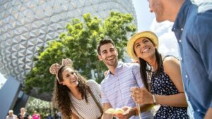 family laughing and enjoying food at Epcot International Food & Wine Festival at Walt Disney World in Orlando, Florida, USA